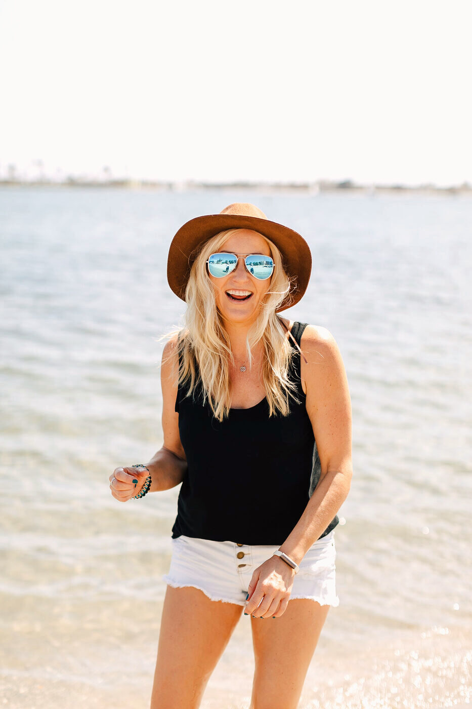 Amber Crocker at the beach in a sunhat