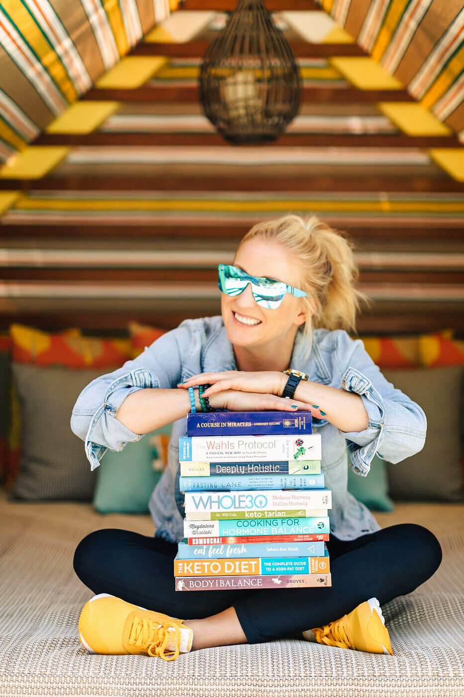 Amber Crocker with a stack of wellness books